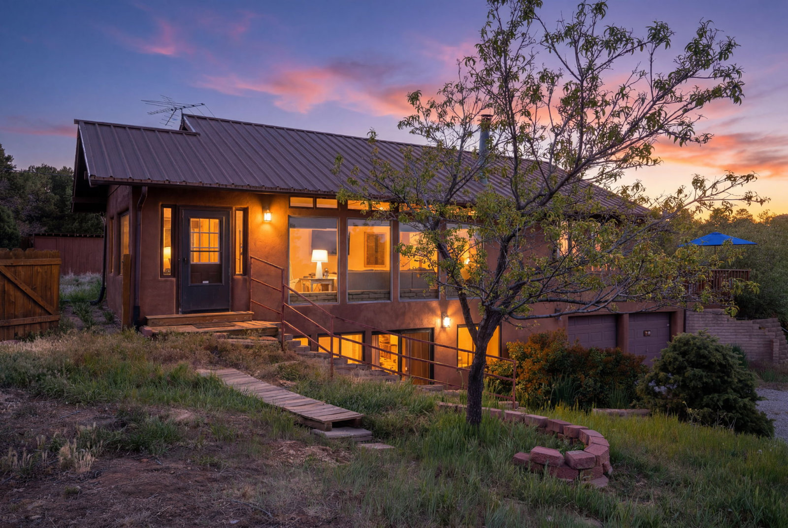 Tijeras two storie home light up at twilight. Homes for sell in Tijeras, NM. Better with Baron Team ABQ. NM.